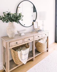 a table with baskets and a mirror on it