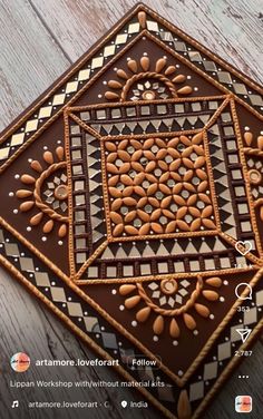 a close up of a decorative tile on a wooden floor with text overlaying it