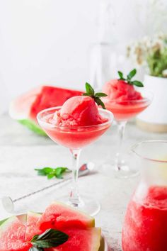 two glasses filled with watermelon sorbet and garnished with mint