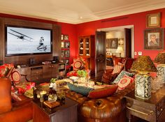 a living room filled with furniture and a flat screen tv mounted to the side of a wall