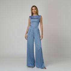 A harmonious blend between comfort and sophistication, our Skye Silk Wide-Leg Pants redefine elegance with every step. Impeccably tailored from blue double silk satin, they present a flattering high-waist with expertly placed darts and a wide-leg cut with a pressed crease detail which visually elongates the silhouette. The concealed zipper and hook fastening in the front ensures ease of wear and a seamless finish.  Match: Complete the look with the Skye Silk Camisole.  Each Il Volo item is handmade by skilfull artisans in our Bucharest atelier and it is created in limited series. 100% Italian Double Silk Satin.  Gentle dry clean. Do not wash. Do not use chlorine based bleach. Do not tumble dry. Cool iron, max 110 C.  Made in EU. Luxury Silk Wide Leg Pants For Evening, Chic Blue Satin Bottoms, Luxury Satin Pants For Workwear, Luxury Satin Pants For Work, Chic Blue Silk Pants, Blue Silk Wide-leg Bottoms, Blue Silk Wide Leg Bottoms, Luxury Satin Pants For Formal Occasions, Luxury Satin Formal Pants