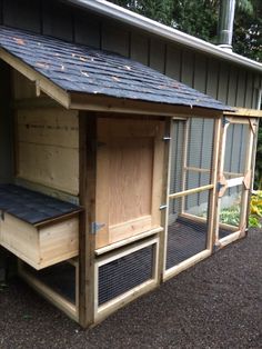 a chicken coop built into the side of a house