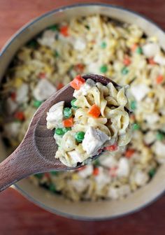 a wooden spoon filled with macaroni salad