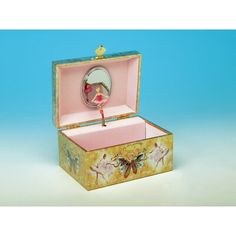 an open box with a pink flamingo figurine in it on a blue background