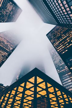 looking up at skyscrapers from below in the foggy day, new york city