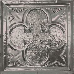 a metal square with an ornate design on it