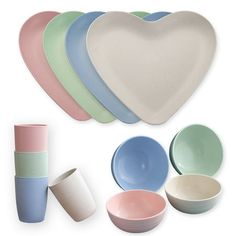 various bowls and cups are arranged in the shape of a heart on a white background