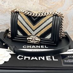 This Piece Was Featured During The 2019 Cruise Collection. Beautiful Authentic Chanel Chevron Embroidered Black, Gold And Silver Small Boy Bag. From The 2019 Collection. The Interior Is Lined In A Black Textile Material. Very Good Condition. Includes Dust Bag, Authenticity Card And Tag. Very Good Condition With Minor Wear And Scuffs Throughout Gold Metal And Leather. Measures Approx 8.07”X5.12”X2.36”. Chanel Chevron, Textile Material, Cruise Collection, Small Boy, Gold And Silver, Chanel Bag, Bags Handbags, Gold Metal, Silver Gold