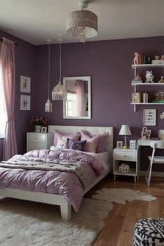 a bedroom with purple walls and white furniture