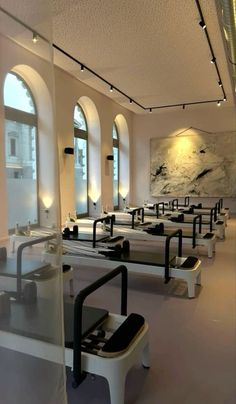 an empty restaurant with tables and benches in front of large windows