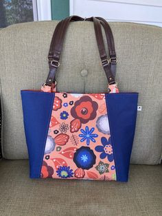 This bag might just make you want to disco as you walk! In a 70's style mod design, this shoulder tote will get you through all seasons and hold everything you need - and more! The flowered fabric is 100% dogwood denim with a tan background with navy, white, green, blue, gray and copper flowers and accents. Designed by Paula Ohreen for Spoonflower. The navy accent fabric is 100% lightweight cotton twill.  Each seam is topstitched with tan thread. Premium interfacing used throughout.  The interio Retro Canvas Bag With Zipper Closure, Retro Shoulder Bag With Zipper Pocket, Retro Shoulder Bag With Zipper For Shopping, Retro Shoulder Bag With Zipper Closure For Shopping, Retro Everyday Shoulder Bag With Zipper Pocket, Retro Shoulder Bag With Zipper Pocket For Everyday, Retro Tote Bags With Zipper Pocket, Spring Shoulder Tote Bag With Zipper Pocket, Retro Canvas Shoulder Bag