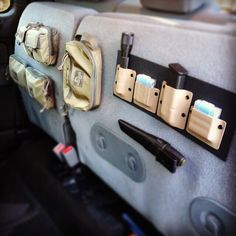 the back seat of a car with several items on it's hooks and straps