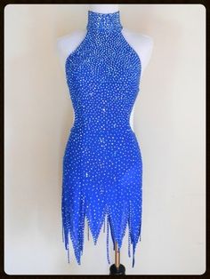 a mannequin wearing a blue dress with white dots on it