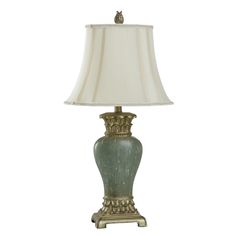 a green lamp with a white shade on it's base and a bird sitting on top