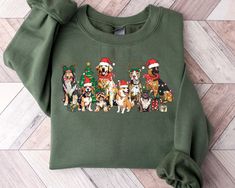 "Christmas Dogs Sweatshirt, Christmas Santa Dog Sweater, Retro Christmas Shirt, Christmas Dog Sweatshirt, Dog Lover Sweatshirt, A B O U T   O U R   P R O D U C T S *Hoodie -Adult unisex sizing,  -Tear away label,  -Ribbed collar,  -Cuffs and waistband with spandex,  -Pouch pocket, double-blend hoodie with matching drawstring  -Mid-weight 8.0 oz. -50% cotton, 50% polyester -Heather sport colors are 60%  polyester, 40% cotton *Sweatshirt -Adult unisex sizing,  -8 oz.(US) 13.3 oz.(CA), 50/50 preshrunk cotton/polyester - Air jet yarn = softer feel and reduced pilling - Double needle stitching at shoulder, armhole, neck,waistband and cuffs  -1 x 1 rib with spandex -Quarter-turned to eliminate center crease -Safety Green: Compliant with ANSI / ISEA 107 - Tearaway label **Please note that these s Retro Christmas Shirt, Dog Lover Sweatshirt, Santa Dog, Christmas Dogs, Lover Sweatshirt, Cotton Polyester Fabric, Christmas Crewneck, Dog Sweatshirt, Holiday Sweatshirt