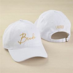 a white hat with the word bride written on it and another cap that says bridal