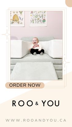 a baby sitting on top of a bed in a room with pink walls and white furniture