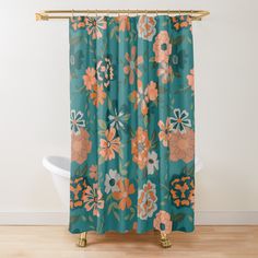 a shower curtain with an orange and blue flower pattern on it, hanging in a bathroom