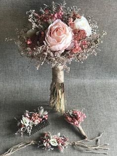 a bouquet of flowers sitting on top of a gray cloth covered table next to scissors