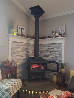 a living room filled with furniture and a fire place in the middle of it's fireplace