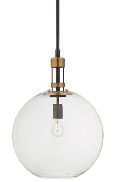 a light fixture with a clear glass ball hanging from it's center and an antique brass finish