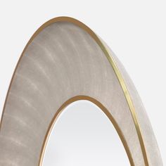 an arch shaped mirror with gold trim around the edges and bottom, on a white background