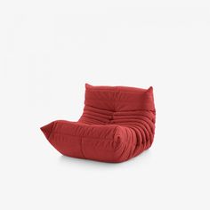 a red chair sitting on top of a white floor