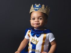 a little boy wearing a crown and sitting down