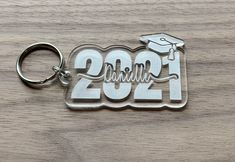 a metal keychain with the word graduation on it