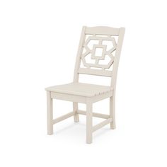 a white wooden chair with an intricate design on the back and seat, against a white background