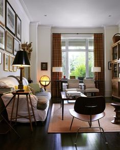 a living room filled with furniture and pictures on the wall