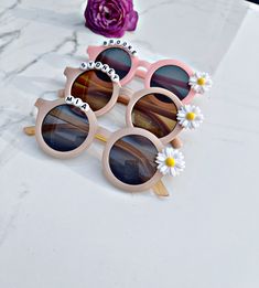 Premium beautiful daisy flower sunglasses for your little girls. Fit best on your child ages 1-6 If you would like to customize with a name(letters), please enter personalization details( on personalization box). The maximum of 12 letters for each sunglasses. If you would like without name (letter) please select without letter and let me know the color on personalization box or message me. Sunglasses are made with ultraviolet-proof with UV400 lenses optical attribute and lightweight . Lens Width Cute Customizable Sunglasses For Gift, Custom Name Sunglasses For Summer Beach, Cute Summer Sunglasses For Birthday, Custom Name Pink Sunglasses With Adjustable Fit, Custom Name Sunglasses For Beach In Summer, Cute White Sunglasses For Gift, White Cute Sunglasses For Birthday, Pink Sunglasses With Custom Name And Adjustable Fit, Cute White Sunglasses As Gift