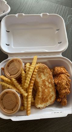 chicken sandwich and french fries in a styrofoam container