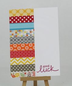 an easel holding a card that says good luck on the front and back side