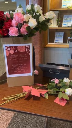 flowers and cards on a table in front of a sign that says, i love you