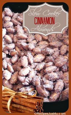 cinnamon almonds are piled on top of each other with cinnamon sticks next to them