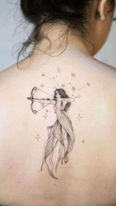 a woman with a bow and arrow tattoo on her back