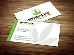 two business cards with the logo herbife nutrition on them, sitting on top of a wooden table