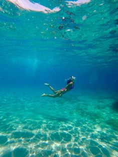 a woman is swimming in the water