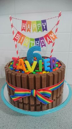 a birthday cake with chocolate frosting and colorful letters on it that spell out the number five