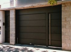 two garage doors are open in front of a house