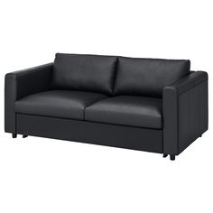 a black leather couch sitting on top of a white floor