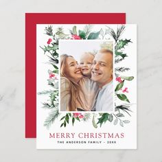 a holiday card with an image of two people and holly wreaths on the front