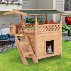 a cat sitting on top of a wooden house