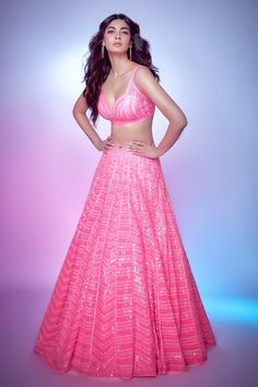 Neon pink lehenga with attached can-can, in a net base with all-over sequin embroidery in a geometric pattern. Comes with matching sweetheart neckline sleeveless padded blouse and a matching dupatta.
Components: 3
Pattern: Embroidery
Type Of Work: Sequin
Neckline: Sweetheart
Sleeve Type: Sleeveless
Fabric: Net
Color: Pink
Other Details: 
Plunge V neckline
Sheer dupatta with scattered sequin embroidery
Chevron pattern
Occasion: Bride - Aza Fashions Pink Self-design Lehenga For Navratri, Pink Party Wear Sharara With Self Design, Pink Self Design Lehenga For Festivals, Festive Pink Lehenga With Self Design, Pink Saree Gown With Self Design, Pink Floor-length Lehenga With Self Design, Pink Bollywood Lehenga With Self Design, Pink Self Design Choli For Navratri, Pink Self-design Choli For Navratri