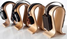 four wooden headphones are lined up in a row