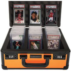 a case filled with baseball cards on top of a white background and an orange handle