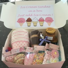 an ice cream sundae in a box filled with treats