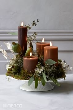 a magazine cover with candles and flowers in it's centerpiece on a table