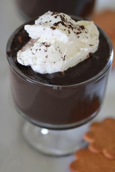 chocolate dessert with whipped cream and cookies on the side